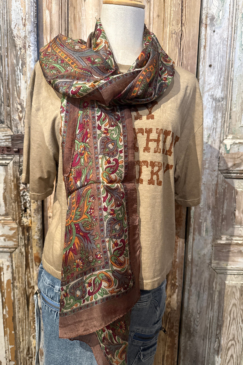 Trestles Clothing Company silk boho scarf with vibrant paisley floral print draped over a mannequin
